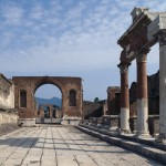 View of the forum with arch in distance and temple columns to right