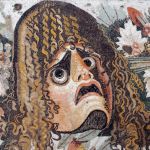 Roman mosaic of a theatre mask with an exaggerated expression of concern