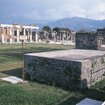 Photograph of the forum at Pompeii, showing the platform used for making speeches in the foreground