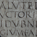Detail of four lines a Roman marble inscription. The letters "I D V B N" from the name "Togidubnus" are visible on the third line.